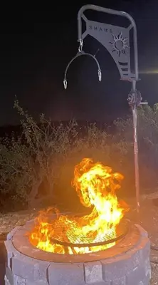 a fire pit with a sign in front of it at Shams Farm in Ajloun