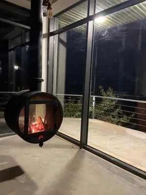 a fire pit in a room with a window at Shams Farm in Ajloun