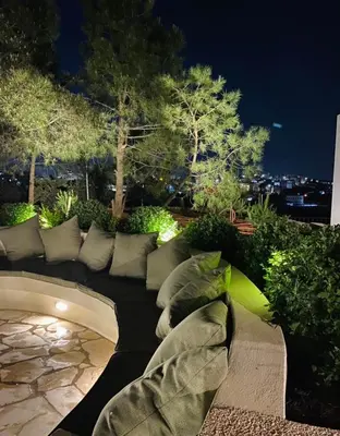 a couch sitting on top of a patio at night at Qaimariya Farmhouse Amman - Day Use - Lodging - Events in Amman