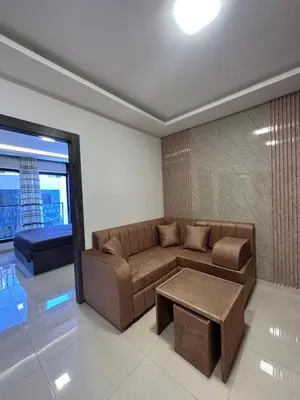 a living room with a couch and a table at modern 2bedroom for rent Abdoun in Amman