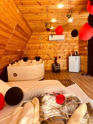 a bedroom with a bed in a wooden room at Widian al-sham huts in Jerash