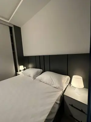a bedroom with two beds and a lamp on a desk at modern 2bedroom for rent abdoun2 in Amman