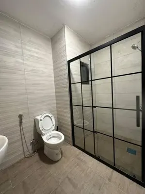 a bathroom with a toilet and a sink at modern 2bedroom for rent abdoun2 in Amman