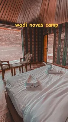 a bed in a room with a sign that reads wax moves camp at wadi novas camp in Wadi Rum