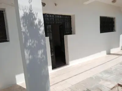 a room with white walls and a door and a floor at petra sun apartment in Wadi Musa