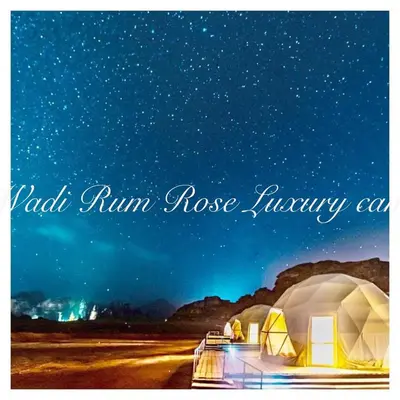 two domes in a desert under a night sky at Wadi Rum Rose Luxury camp in Wadi Rum