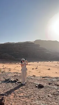 a bride and groom standing in the desert at Sidra Luxury Camp in Rum in Wadi Rum