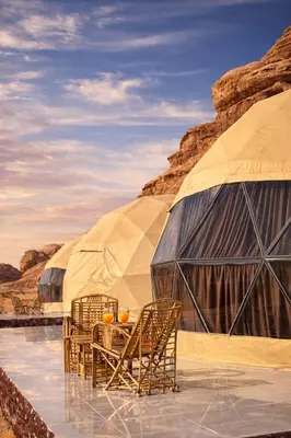 a table and chairs in front of a tent at Sidra Luxury Camp in Rum in Wadi Rum