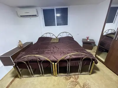 a large bed in a room with a mirror at Beit Al Hasan بيت الحسن in Um Qeis
