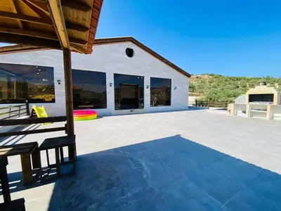 a large patio with a building with large windows at Souf view in Jerash
