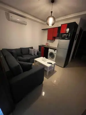 a living room with a couch and a kitchen at apartment 60m 1bedroom for rent3 in Umm Uthainah