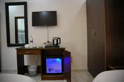 a small tv in a room with a mirror and a tvicterictericter at Mansi Residence in Wadi Musa