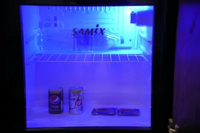 a refrigerator with two cans of soda in it at Mansi Residence in Wadi Musa