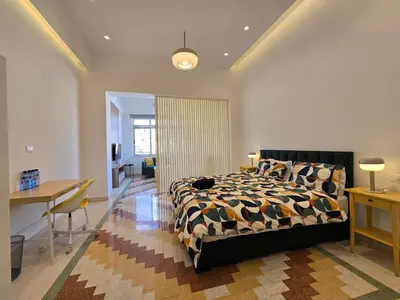 a bedroom with a bed and a table and a desk at Downtown Living Boutique Apartments in Amman