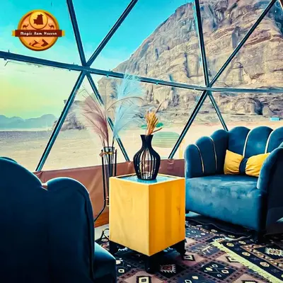 a living room with two blue couches and a table at MAGIC RUM lUXURY HUSSEN in Wadi Rum