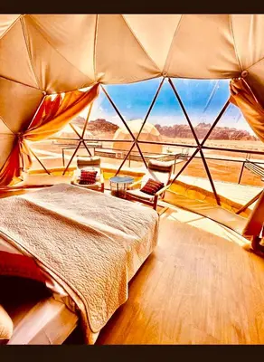 a room with a bed and a large window at MAGIC RUM lUXURY HUSSEN in Wadi Rum