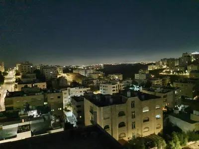 a view of a city at night at Suad Apartment in Amman