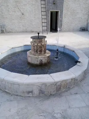 a fountain in a courtyard in front of a building at شقة فاخرة مع مطل luxerious with nice view in Amman