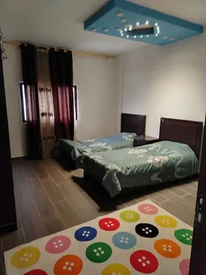 a room with two beds and a rug on the floor at شقة فاخرة مع مطل luxerious with nice view in Amman