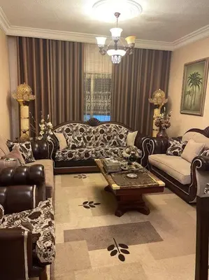 a living room with a couch and a coffee table at 3 bedroom apartment in Ţāb Kirā‘