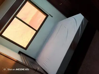 a bedroom with a window and a bed in a room at شقق المومني in Amman