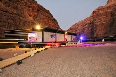 a building in front of a mountain at night at Imagination Luxury Camp in Disah