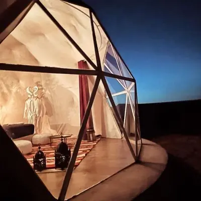 a glass dome with a statue in the background at Golden Gate Luxury Camp in Wadi Rum
