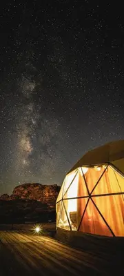 a large tent under a starry night sky at Golden Gate Luxury Camp in Wadi Rum