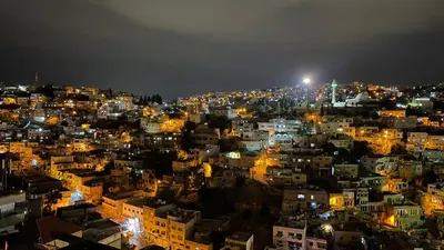 a view of a city at night with lights at Saraya locanda in Al Salt