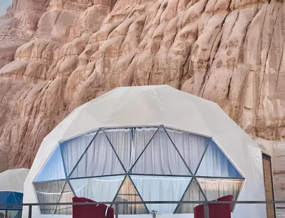 a tent in front of a rock wall at Shebara Camp Wadi Rum in Wadi Rum