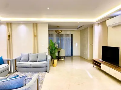 a living room with a couch and a tv at Odeh Residence in Aqaba