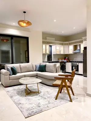 a living room with a couch and a table at Odeh Residence in Aqaba
