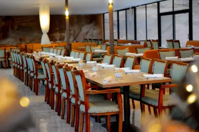 a dining room with a long table and chairs at Shell Luxury Camp in Wadi Rum