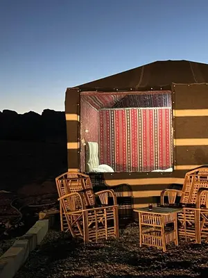 a group of wicker chairs sitting outside of a building at Mira Bedouin Camp in Wadi Rum