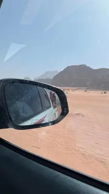 a side view mirror of a car in the desert at Mira Bedouin Camp in Wadi Rum