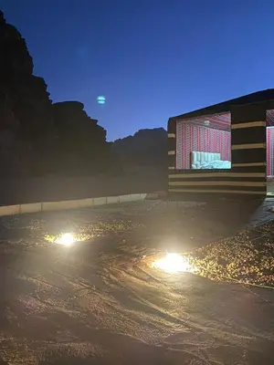 a building with lights on the street at night at Mira Bedouin Camp in Wadi Rum