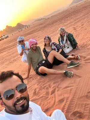 a group of people sitting in the desert at Mira Bedouin Camp in Wadi Rum