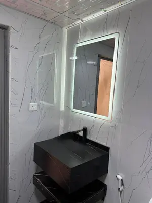 a bathroom with a mirror and a black sink at Wadi Rum Marina Camp in Wadi Rum