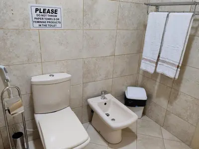 a bathroom with a toilet and a bidet at CMK Housing in Madaba