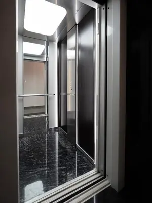 a bathroom with a glass door with a window at ENG-Murjan Apartment in Aqaba