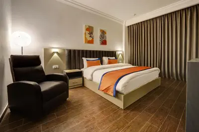 a hotel room with a bed and a chair at The Loft hotel By FHM in Aqaba