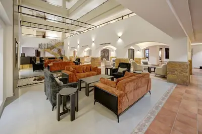 a large living room with couches and tables at The Loft hotel By FHM in Aqaba