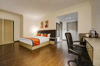 a bedroom with a bed and a desk and a chair at The Loft hotel By FHM in Aqaba