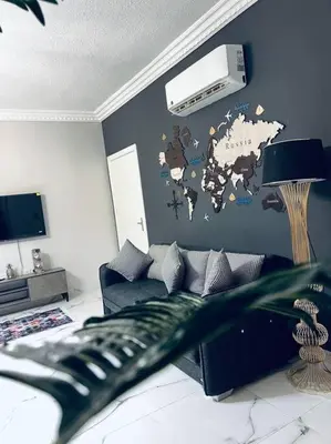 a living room with a couch and a wall at Luxury 4-bedrooms apartment in Aqaba