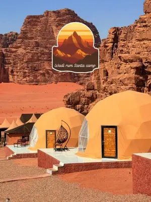 a group of three tents in the desert at Wadi Rum Santa Camp in Wadi Rum