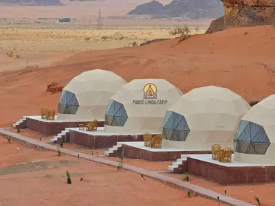 a group of white tents in the desert at wadi rum,Linda Camp in Wadi Rum