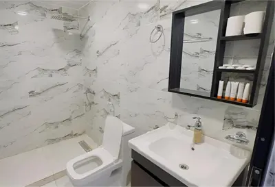 a white bathroom with a toilet and a sink at The bubble camp in Wadi Rum