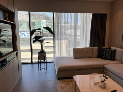 a living room with a couch and a large window at DAMAC Luxury new 1 bedroom apartment in Amman