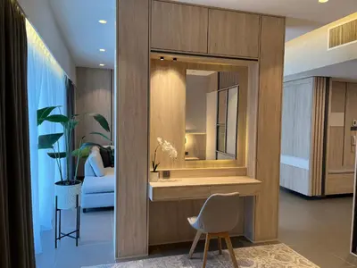 a living room with a mirror and a chair at DAMAC Luxury new 1 bedroom apartment in Amman