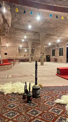 a large room with a large rug on a floor with a chess at Wadi Rum Desert Bedouins in Wadi Rum